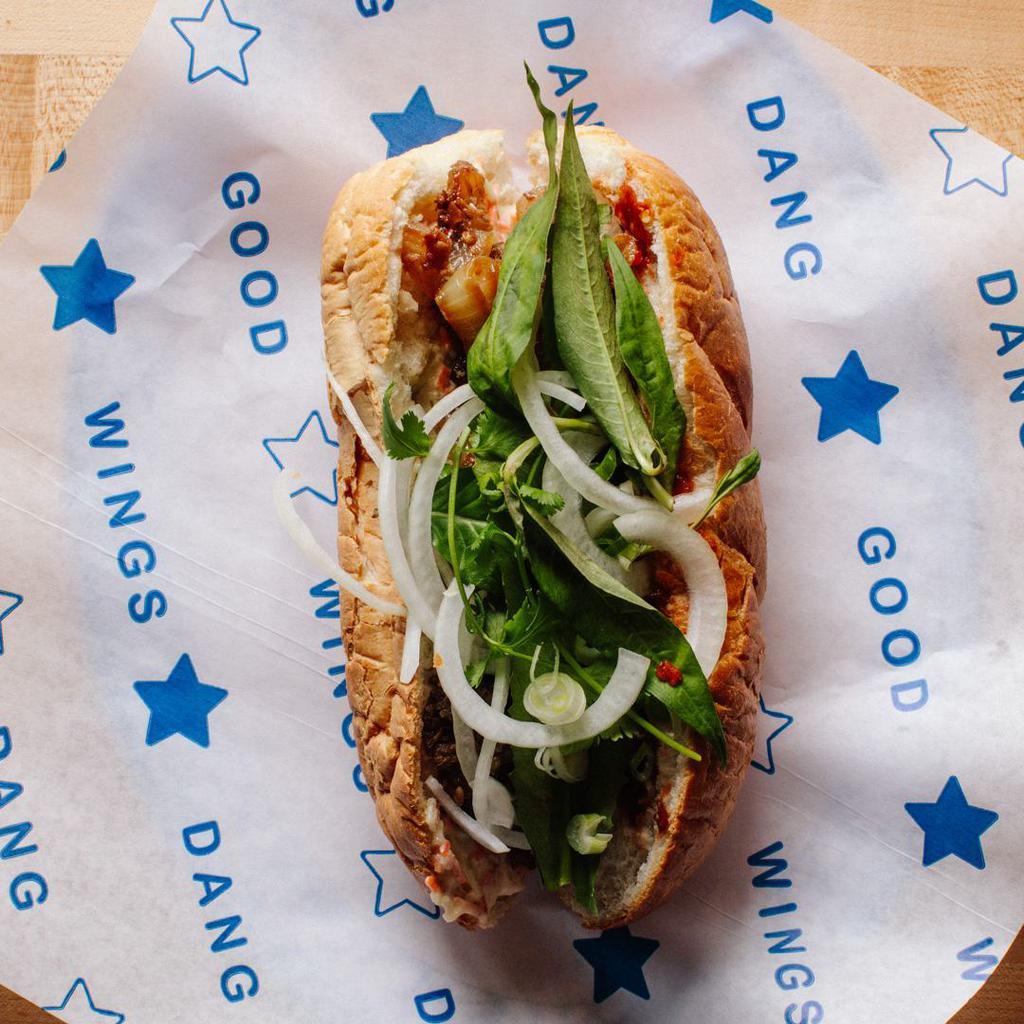 Banh Mi by Dang Good Wings All Day · By Dang Good Wings All Day. Vietnamese sandwhich with choice of protein, pickled papaya, carrot mayo, sliced onions, and Vietnamese mix herbs. Chili sauce on the side. Contains gluten and soy. We cannot make substitutions.