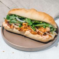 Banh Mi · Vietnamese sandwhich with choice of protein, pickled papaya, carrot mayo, sliced onions, and...