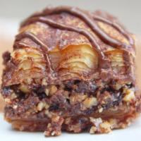 Cocoa Baklava · Layers of phyllo dough and chocolate sprinkled with nuts and cinnamon topped with chocolate ...
