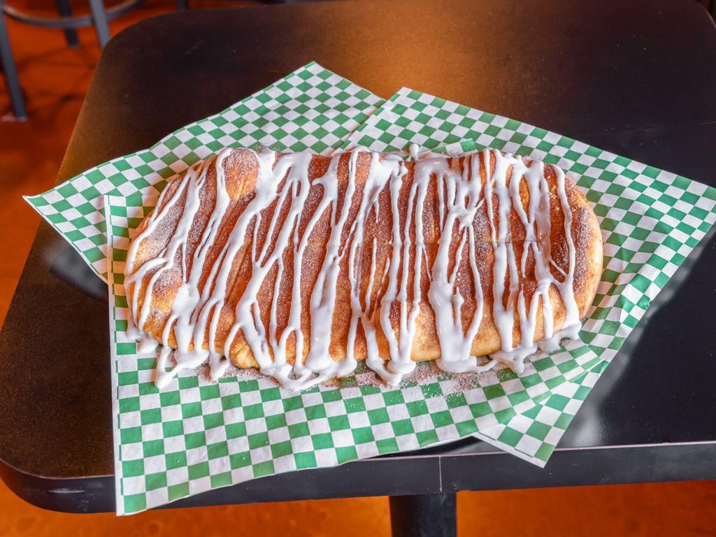 Cinna Stix · Oven baked bread topped with cinnamon, sugar, and icing.