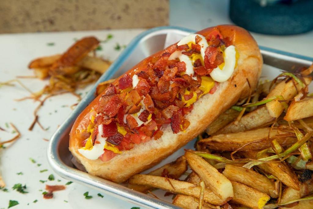 Sonoran Hotdog · Noble Bread bun, all-beef hot dog, topped with diced onion, tomato, mustard, crispy bacon.