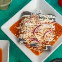 Red Enchilada Suizas · Blue corn tortilla, chicken tinga, Oaxaca cheese, topped with chile de arbol sauce, crema, r...