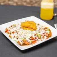 Patacones · Fried green plantains served with chicken or beef, ham, cheese & pico de gallo
