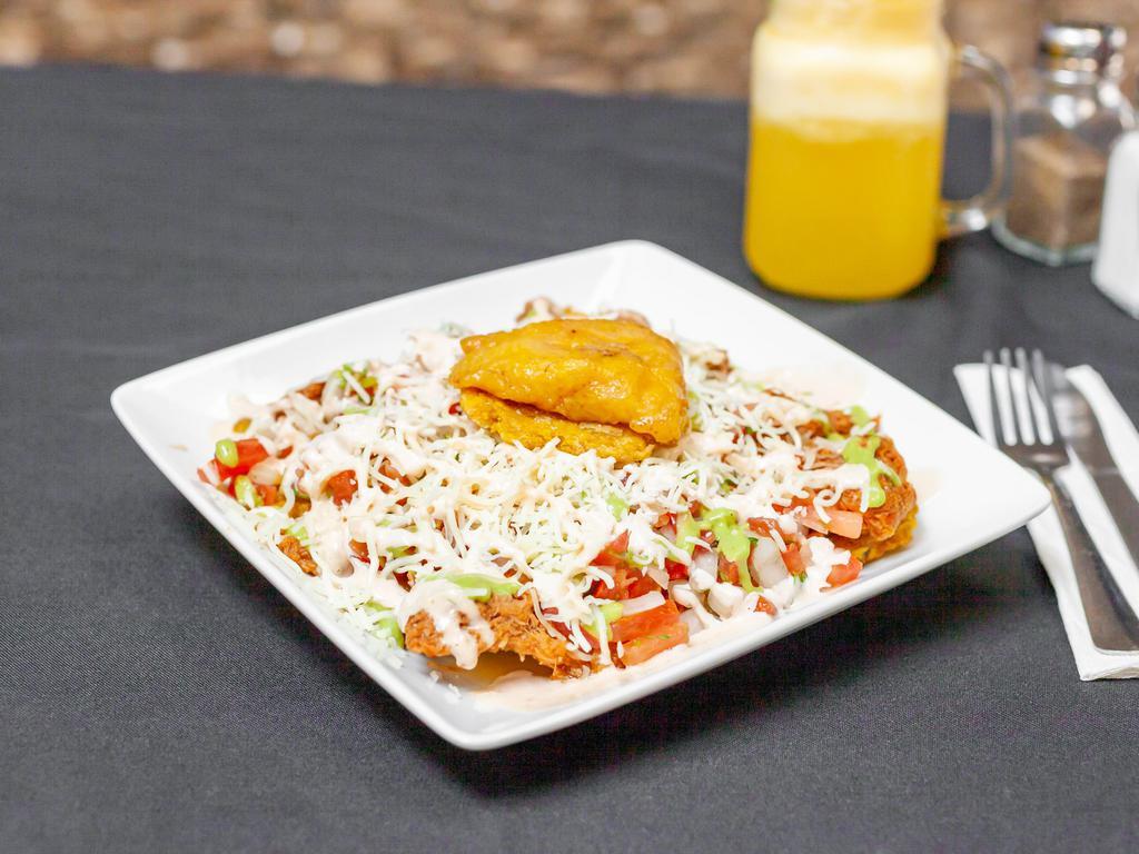Patacones · Fried green plantains served with chicken or beef, ham, cheese & pico de gallo