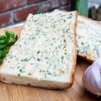 Garlic Bread · Bordenave's Sourdough Bread spread with our tasty homemade garlic butter