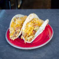 El Jefe Taco · Soft corn or flour taco with eggs, double bacon, potatoes and shredded cheese. Served with a...