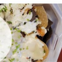 Nachos · Served with chips, cheese, sour cream, and pico de gallo.