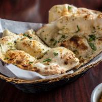 Garlic Naan Bread · Chunks of garlic cooked within our famous oven-baked flatbread. Chef's recommendation.
