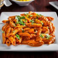 Penne Tikka Masala · Penne pasta sauteed in our homemade buttery cream sauce topped with your choice of tandoori ...