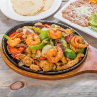 Mix Fajita Shrimp and Steak and Chicken · Served with grilled onions, peppers, yellow rice, refried beans, salad, sour cream guacamole...