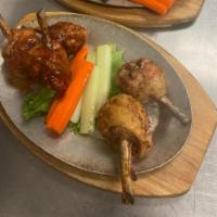 Smoked & Fried Drumstick Lollipops · (5) DRUMSTICK LOLLIPOPS SERVED WITH A SIDE OF CARROTS & CELERY WITH RANCH OR BLUE CHEESE. TH...