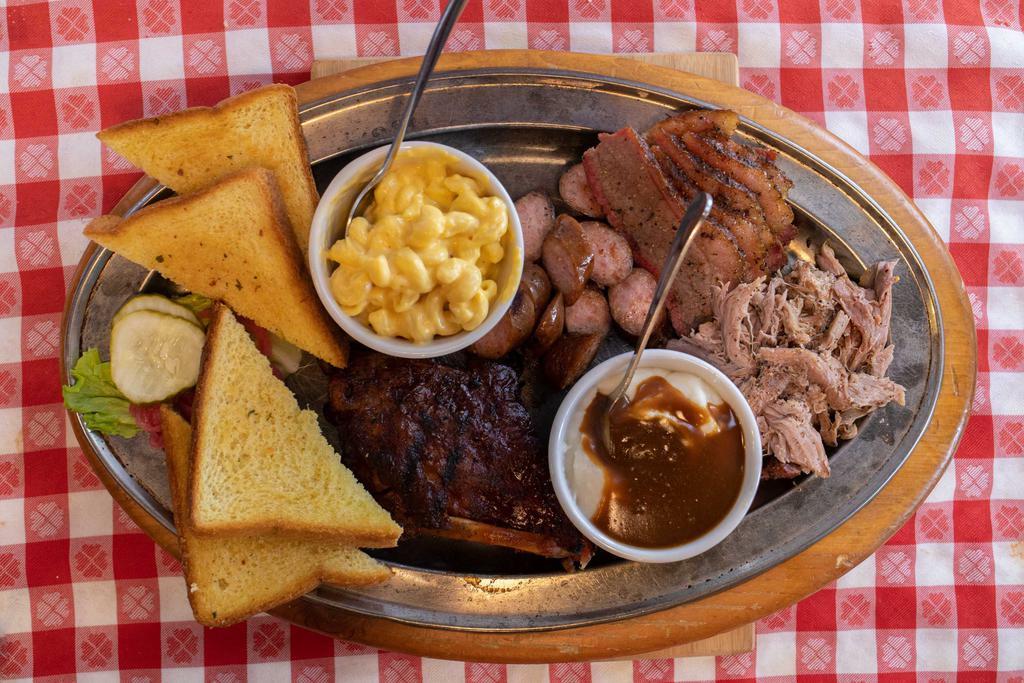 Sampler Platter · BUILT TO SHARE. ALL FOUR MEATS AND ANY TWO SIDES WITH TEXAS TOAST. THIS ENTREE IS GLUTEN FREE WHEN YOU ADD G.F. BUNS AND CHOOSE G.F. SIDES