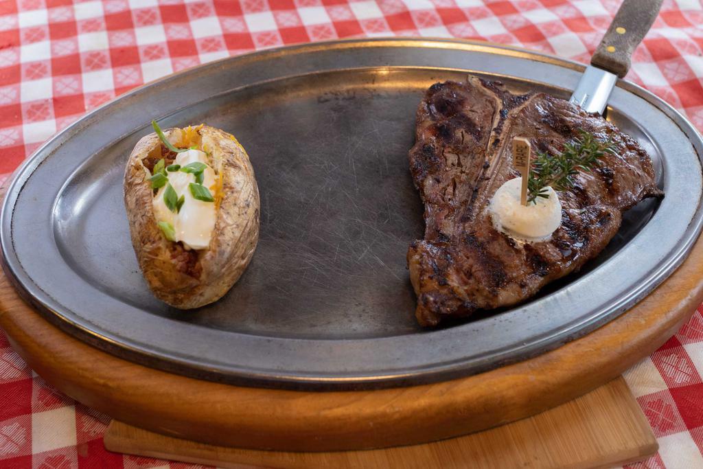 T-Bone · BOLD, BEEFY NEW YORK STRIP ON ONE SIDE AND A TASTE OF MILD, TENDER FILET MIGNON ON THE OTHER.  INCLUDES ANY ONE SIDE. THIS ENTREE IS GLUTEN FREE BASED ON YOUR SIDE CHOICE