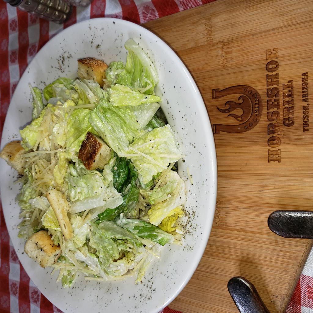 Caesar Salad (gf*) · ROMAINE LETTUCE TOSSED IN CREAMY CAESAR DRESSING SPRINKLED WITH SHREDDED PARMESAN CHEESE AND TOASTED CROUTONS. (gf without croutons)
