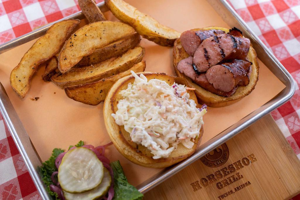 Smoked Polish Sausage Sandwich · WITH APPLE COLESLAW AND ORIGINAL BBQ SAUCE ON A TOASTED BUN. INCLUDES FRESH-CUT FRIES, SUB AND SIDE FOR 1.99. THIS ENTREE IS GLUTEN FREE WHEN YOU ADD A G.F. BUN AND CHOOSE G.F. SIDES
