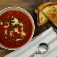 Tomato Bisque Soup · Our hearty tomato broth, cream drizzle, toasted garlic, chili flakes, parsley flakes.