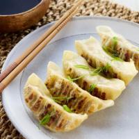 HK Beef Gyoza · Spicy sesame soy dipping sauce.