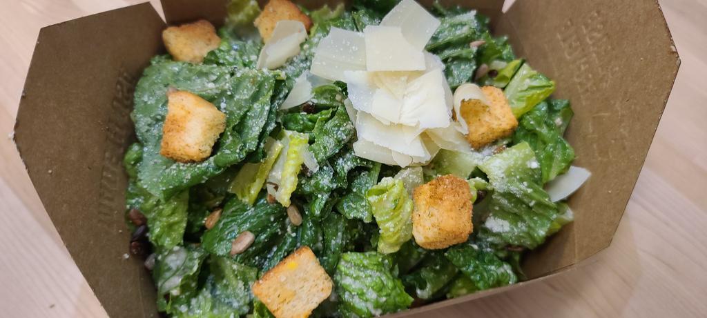 Caesar Salad · Romaine tossed in Parmesan, toasted sunflower seeds, croutons, and Caesar dressing.