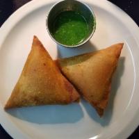 Vegetable Samosas (Vegan) · Triangular puffed pastry stuffed with mashed potatoes, green peas, carrots & mildly spiced h...
