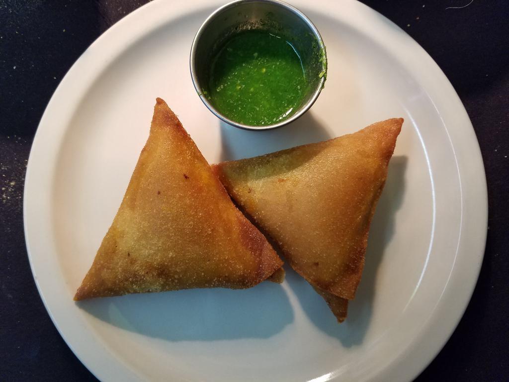 Vegetable Samosas (Vegan) · Triangular puffed pastry stuffed with mashed potatoes, green peas, carrots & mildly spiced herbs.