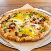 Breakfast Pizza · Mozzarella, Gruyere, sunny side up egg, smoked bacon, and green onions.