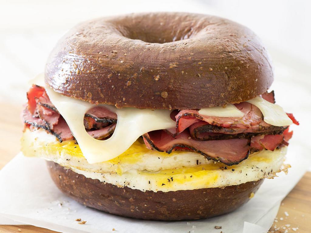 Pastrami, Egg & Swiss · Perfectly seasoned, fresh-cracked eggs plus thinly sliced pastrami, served up hot with Swiss cheese on a Pumpernickel Bagel.
