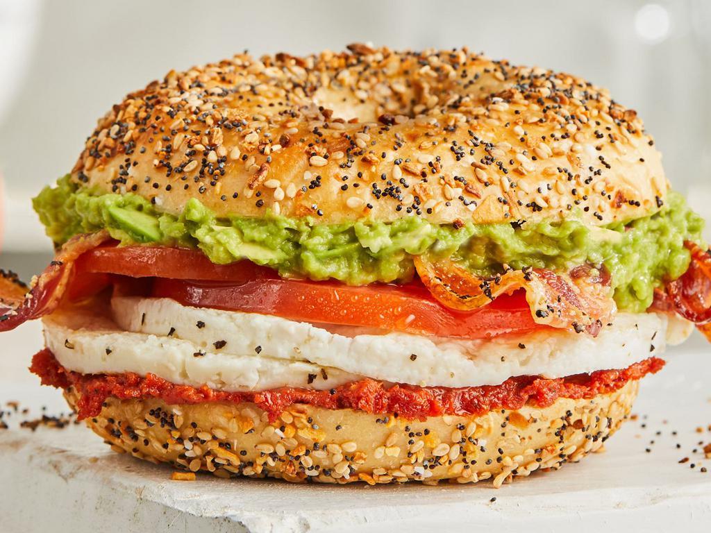 Skinny Bacon, Avocado, & Tomato Egg White · A skinny cut Everything Bagel loaded with fresh flavor from perfectly seasoned egg-whites, black-pepper bacon, avocado, fresh tomatoes, and our signature sun-dried tomato spread.