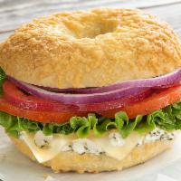 Leonardo Da Veggie · Our Asiago Parmesan Bagel stacked with red pepper, lettuce, tomato and red onion, topped wit...