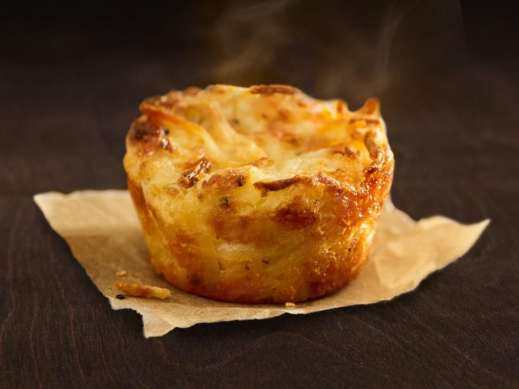 Twice-Baked Hash Brown · Crispy shredded potatoes mixed with mozzarella, provolone, cheddar, parmesan, asiago, and romano cheese, filled with both plain and onion and chive cream cheese.