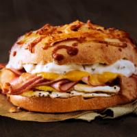 Farmhouse Egg Sandwich · Cheesy Hash Brown Gourmet Bagel with bacon, ham, cheddar cheese, and a country pepper shmear.
