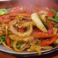 Chicken Fajitas · Tender strips of chicken breast, mixed with sauteed onions with green and red peppers. Serve...