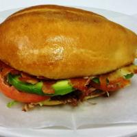 Torta · Mexican sandwich. Carnitas (roast pork), pollo (chicken), pastor (marinated pork), ground be...