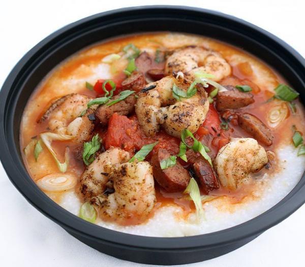 Shrimp and Grits · Creamy stone ground grits served with Cajun sauce of sauteed shrimp, chicken sausage, tomatoes and onions.