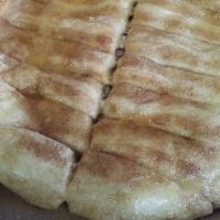 Cinnamon Bread · 16 piece sweet breadstick covered in butter and cinnamon sugar. Includes 1 side of icing.