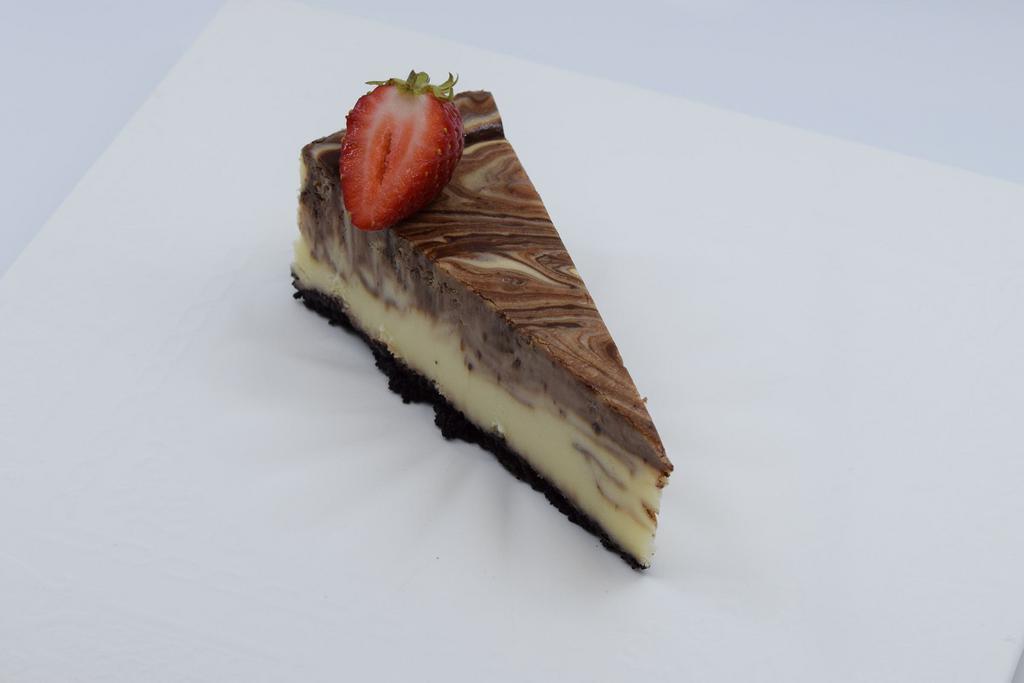 Chocolate Cheesecake · A rich classic decadent blend of smooth chocolate cheesecake and fluffy Belgian chocolate mousse in a chocolate crust.