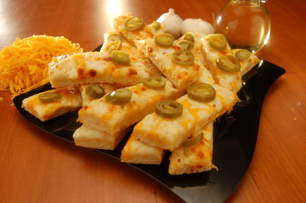 Jalapeno Bread · Ranch covered in mozzarella and cheddar cheese with jalapenos.