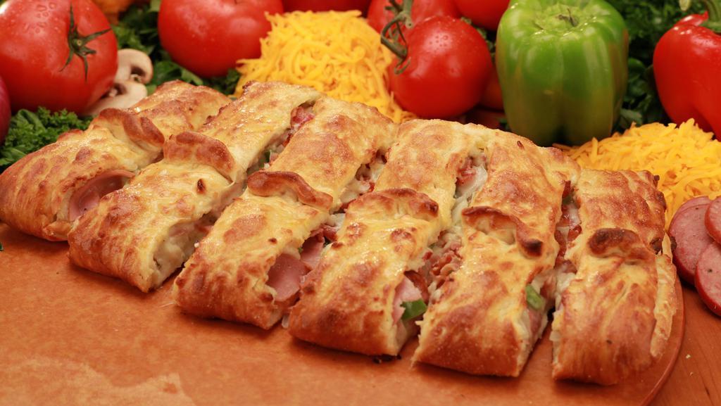 Stromboli · A golden brown crust studded with Canadian bacon, bacon, green peppers, onions, cheese, and ranch dressing.