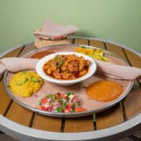 Doro Tibs · Tender, marinated piece of chicken sauteed in spiced butter with peppers and onion.