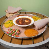 Doro Wot · Traditional dish, chicken stew simmered in berbere sauce, herbal butter, and boiled egg serv...