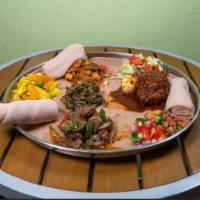 Meat Combo · Four or more of our spicy meat dishes on top of injera, Ethiopian flat bread.
