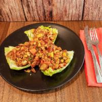 Kona Chicken Lettuce Wraps  · Crispy sweet and spicy chicken tenders with grilled pineapple-jicama salsa in fresh lettuce ...