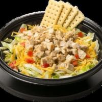 Chicken Fiesta Salad · Lettuce, Cheddar Cheese, Diced Tomatoes, Fajita Chicken with a side of Carrots and Crackers.