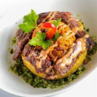 The Bowl · Green fried mashed plantain stuffed with saute rice and skirt steak, chicken, shrimp, or veg...
