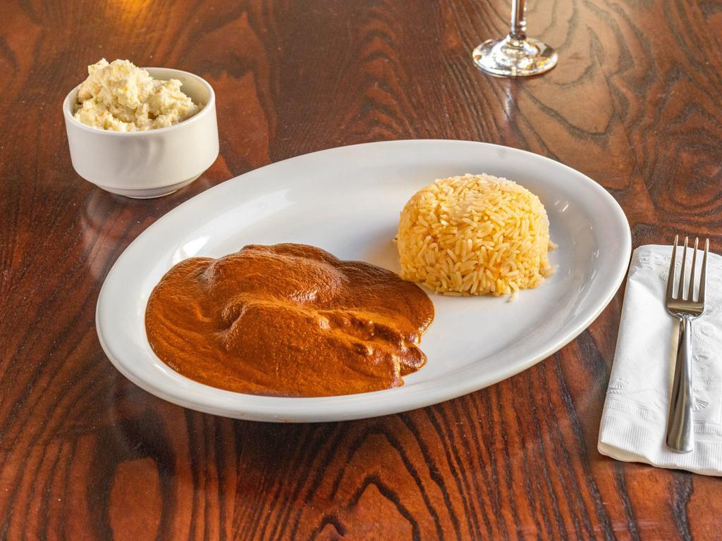 House Mole · Absolutely made from scratch! Our traditional sauce made from chili peppers and served over shrimp or chicken and a side of spanish rice. Contains nuts.