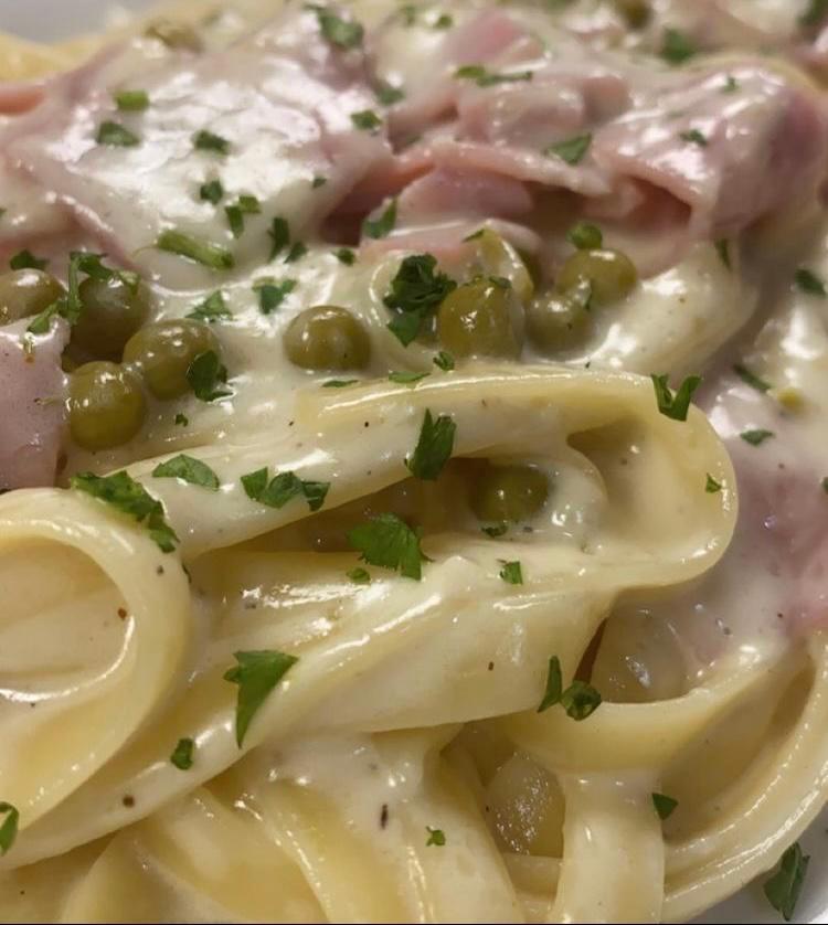 Fettuccine alla donna (Lunch) · Fettuccine pasta tossed in a creamy garlic sauce with prosciutto and peas. 