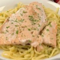 Grilled Salmon Pesto · Grilled Salmon topped with creamy pesto sauce served with a side of linguine pasta tossed in...