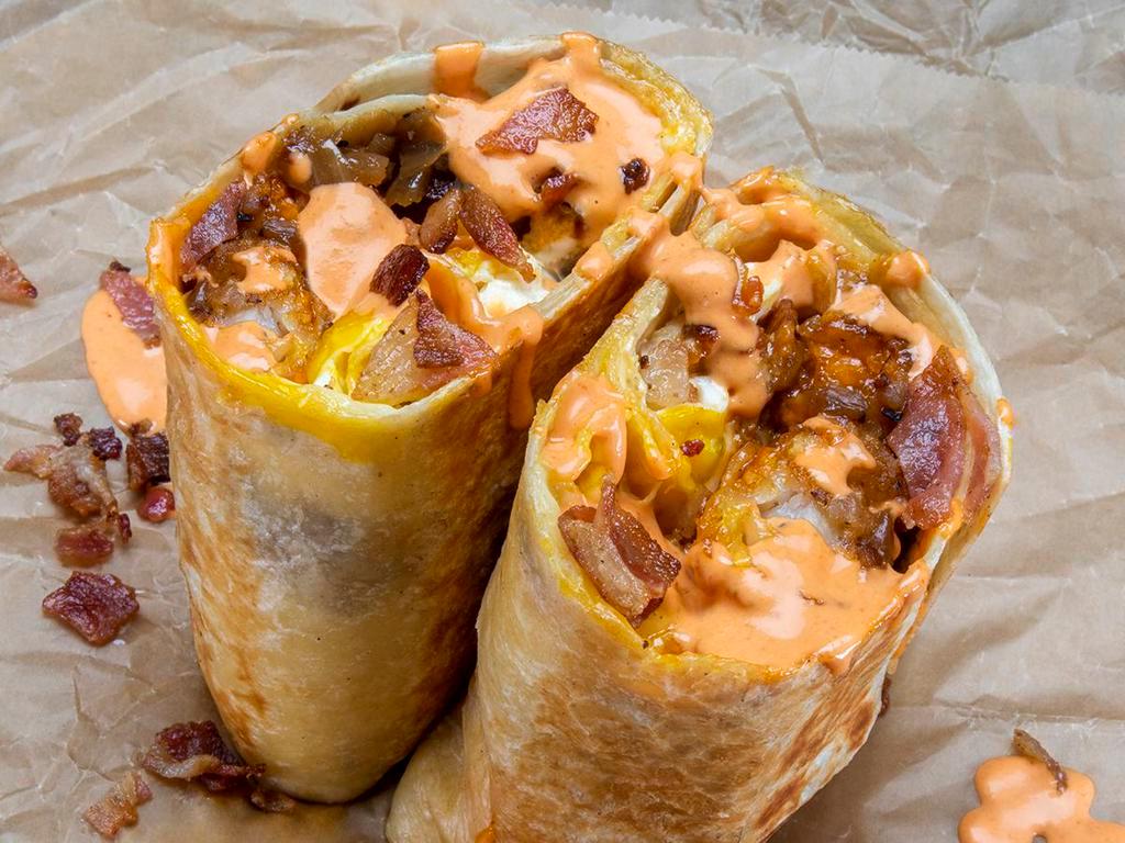 Haus Burrito · 3 eggs, smoked bacon, white American cheese, crispy tater tots, caramelized onions, spicy mayo; sides of spicy mayo & hot sauce.