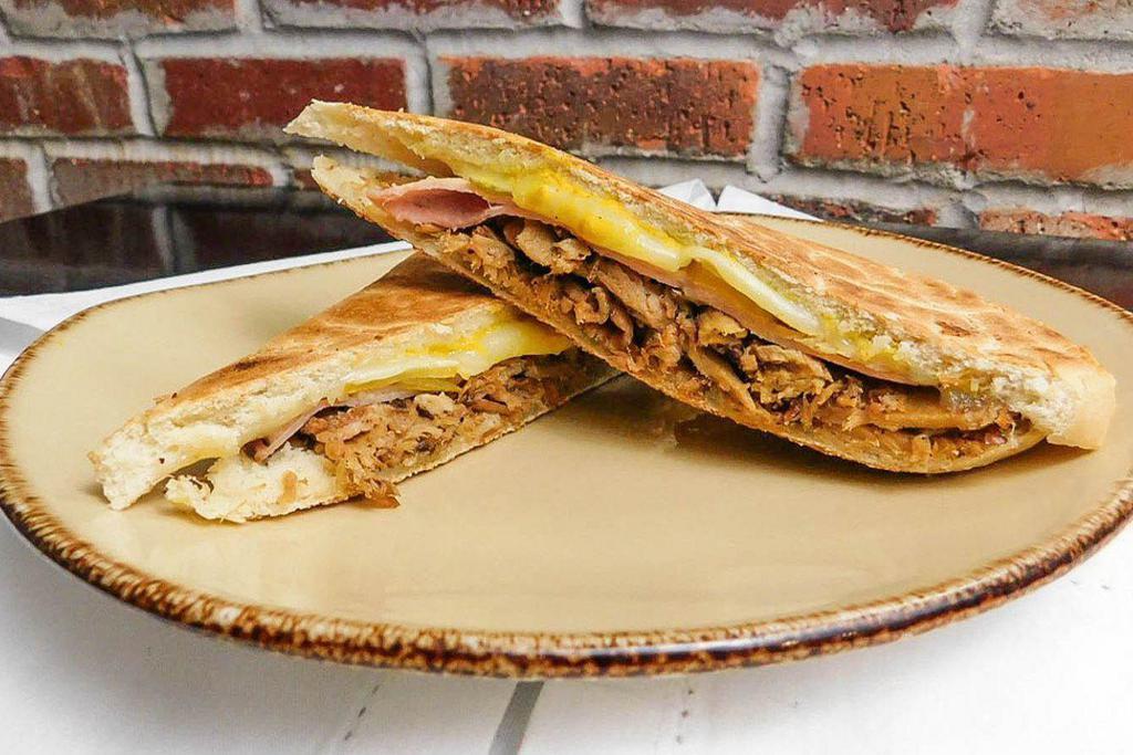 Cubano Pressed Sandwich · Roasted pork, ham, Swiss cheese, pickles and mustard.
