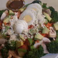 Cobb Salad · Romaine lettuce, hard-boiled egg, broccoli, mushrooms, avocado, tomatoes, blue cheese, with ...