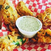 Cheezy Creole Pop’ens · Lightly sauteed fresh jalapeños wrapped in our Creole Cheeze, battered and served with our c...